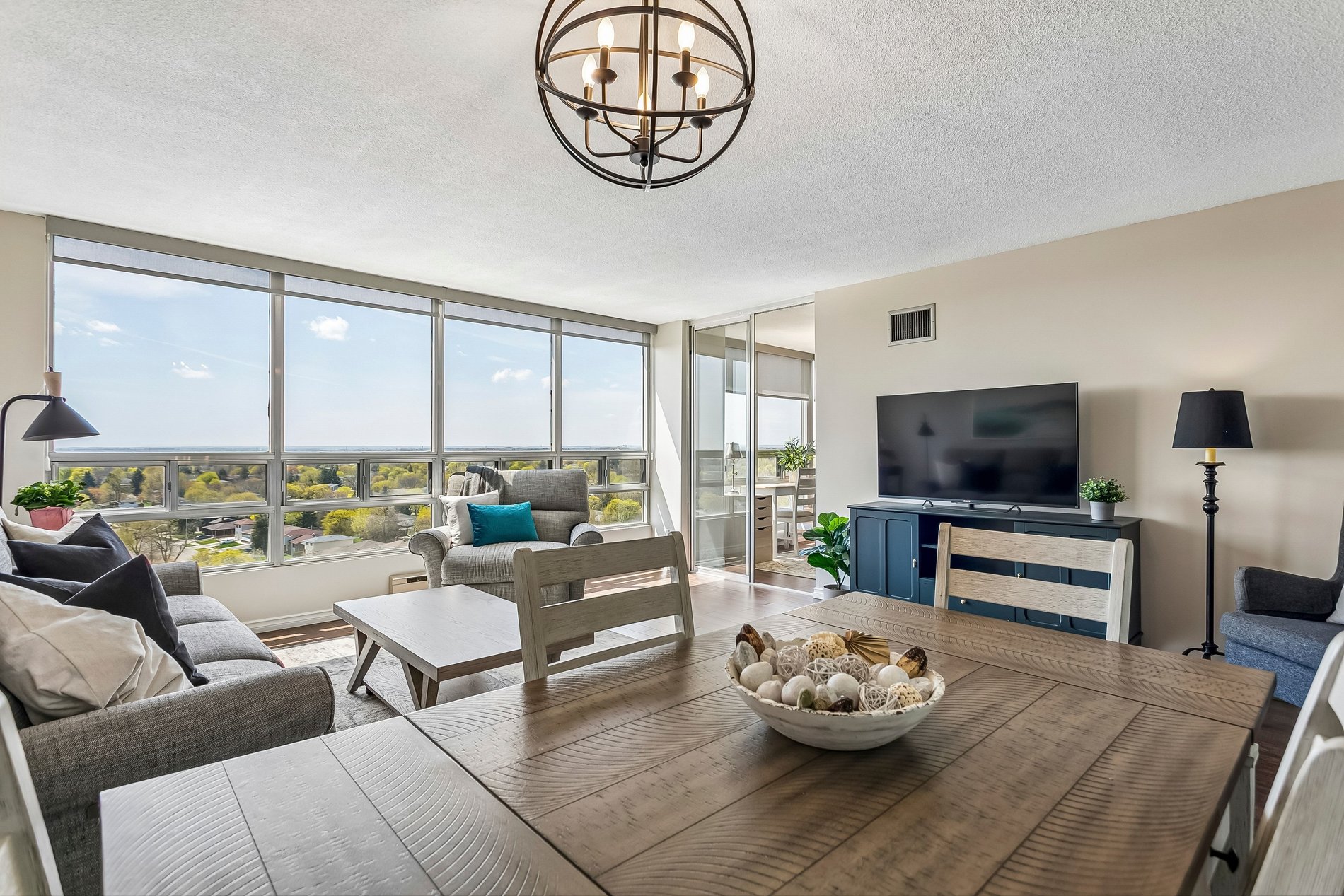 Bright living and dining area with expansive windows and scenic views