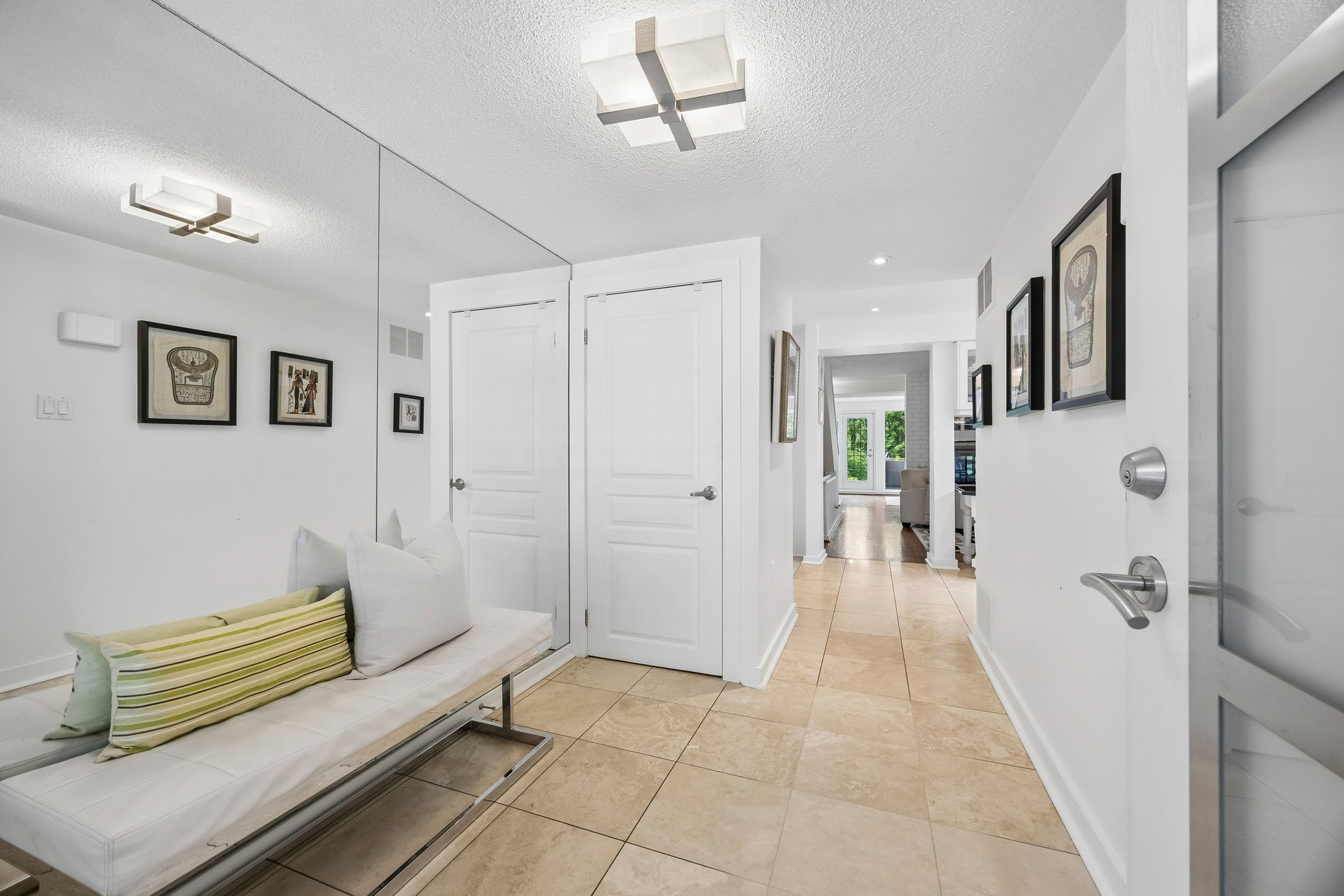 Clean, spacious home entryway with tile flooring and modern finishes