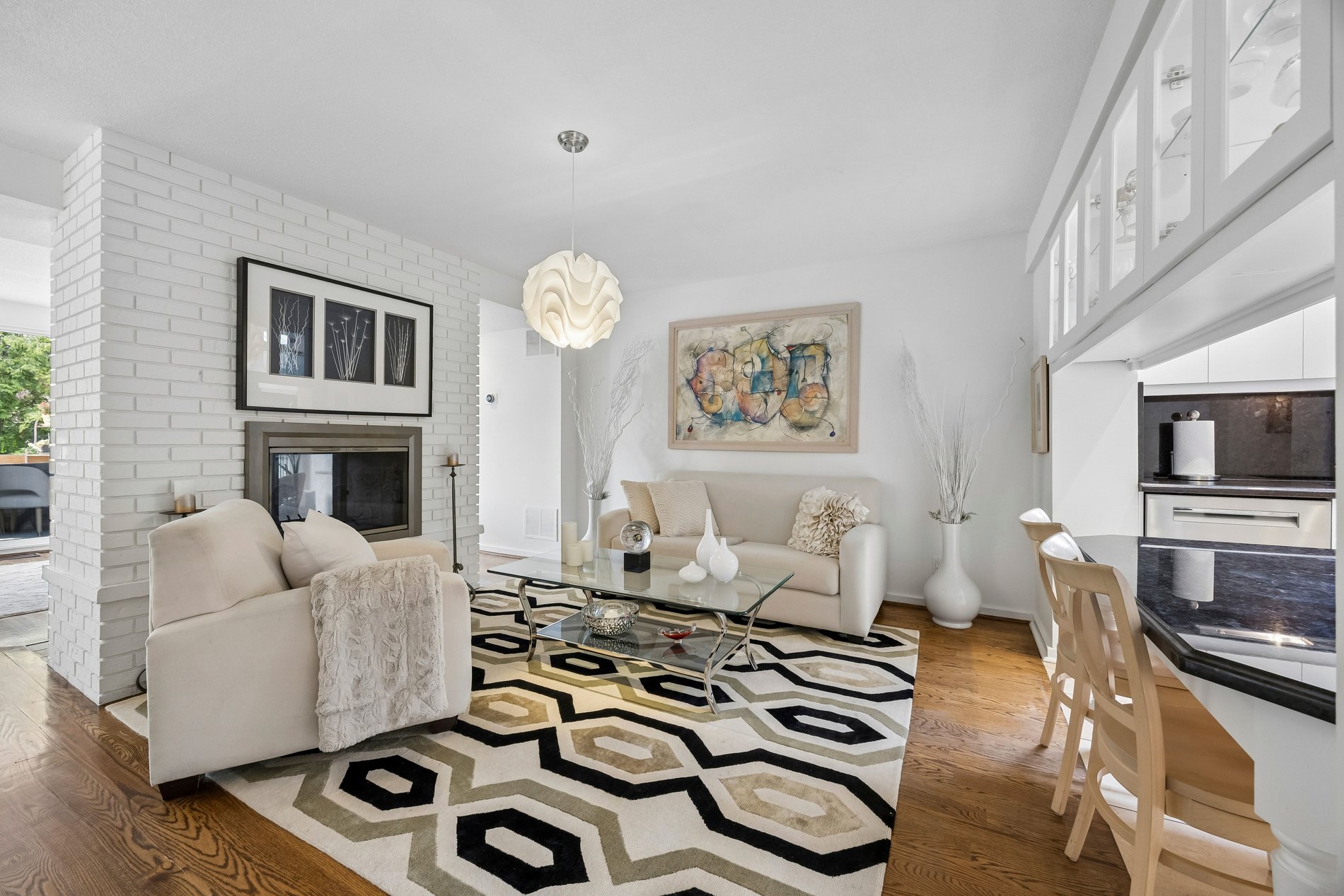 Bright modern living room with fireplace, hardwood floors, and open-concept layout
