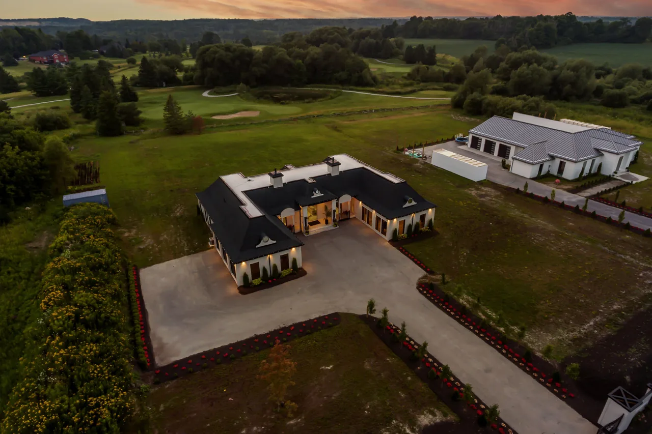 Dusk aerial of a modern estate overlooking rolling countryside